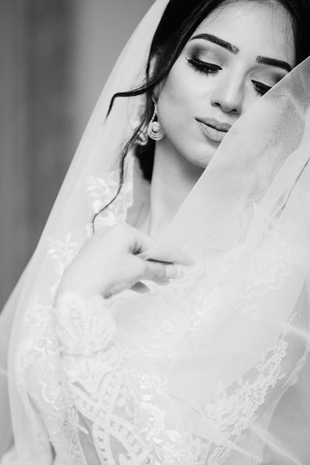 Woman in white wedding dress closing eyes