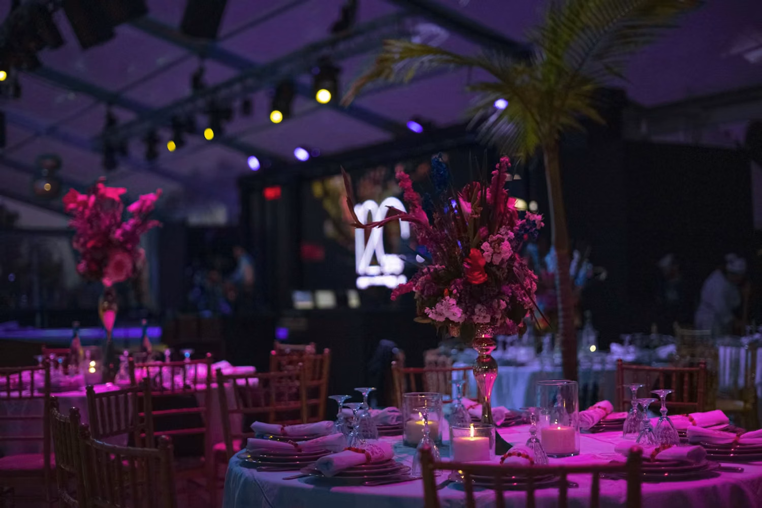 A table set up for a party with candles and flowers